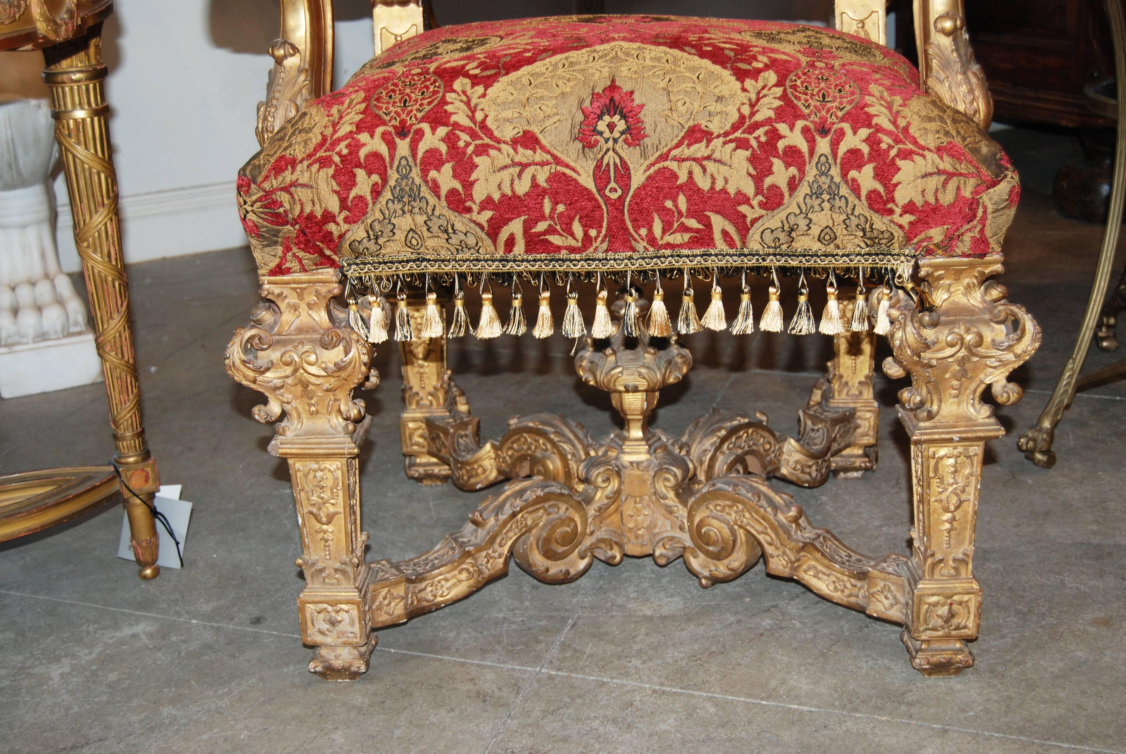 Beautifully carved and gilded armchairs.