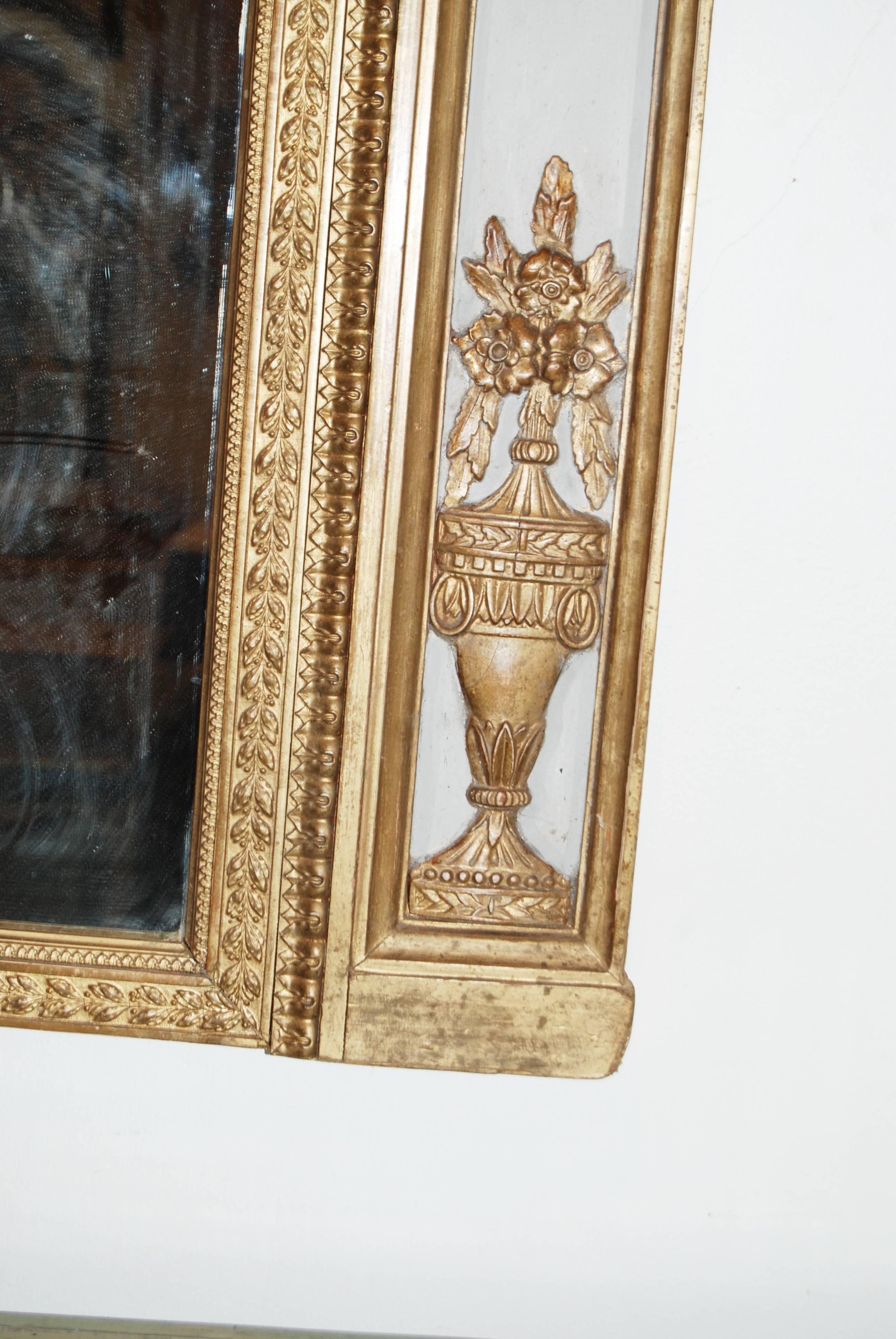 Carved and gilded trumeau mirror.