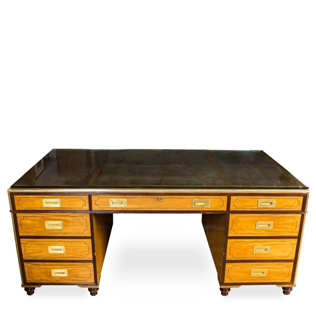 A Classic partner's desk by Baker Knapp & Tubbs, USA, circa 1960. Features contrasting wood finishes complemented by brass hardware.