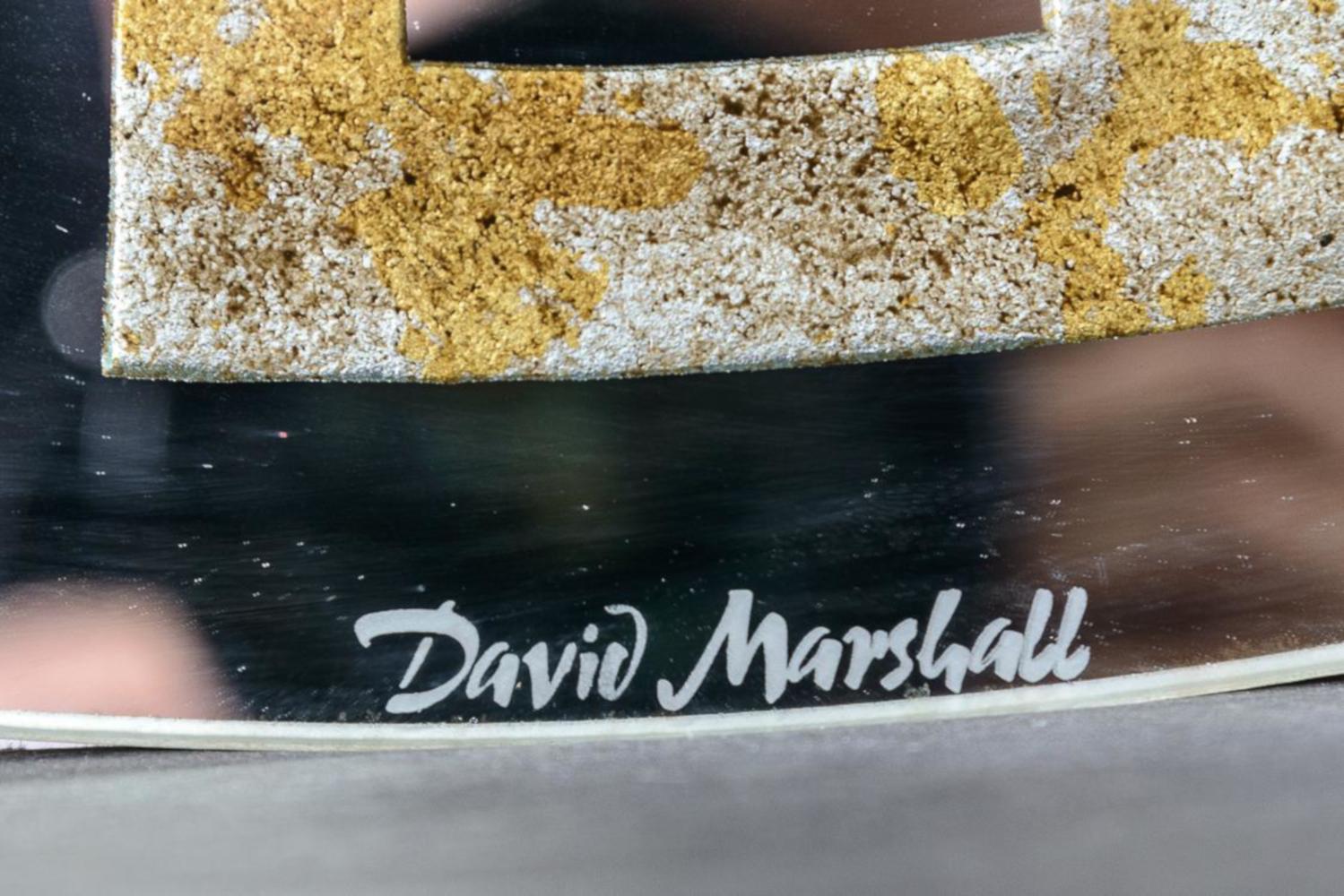 Round, David Marshall, signed mirror with reverse gilt Greek key detail. Each segment of the Greek key design is reverse gilt with gold, silver and copper leaf. Mounted on a round wood backing.

  