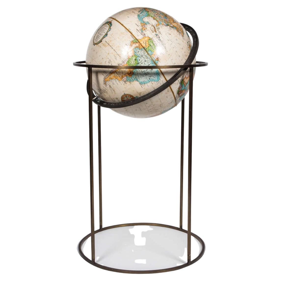 World globe by Replogle in the style of Paul McCobb, USA, circa 1970. Signed.

Beige globe supported by swivel stand in antiqued brass. Featuring square tube design made popular by McCobb.