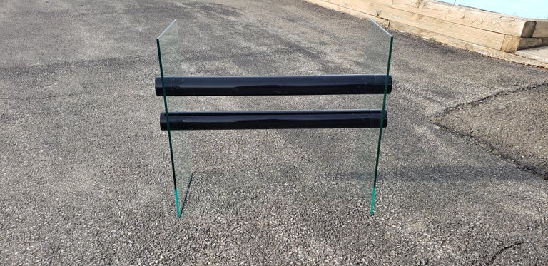 Fantastic, clean lined. Made from three sheets of glass with a pair of powder coated steel rods for stretchers.