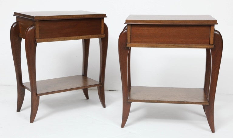 Pair of modernist nightstands with drawer and lower shelf. In the style of Andre Arbus, France, circa 1950. Made of French oak newly and beautifully refinished in a walnut stain.

Dimensions of tabletop area:
17.75 inches L,
11.25 inches W.