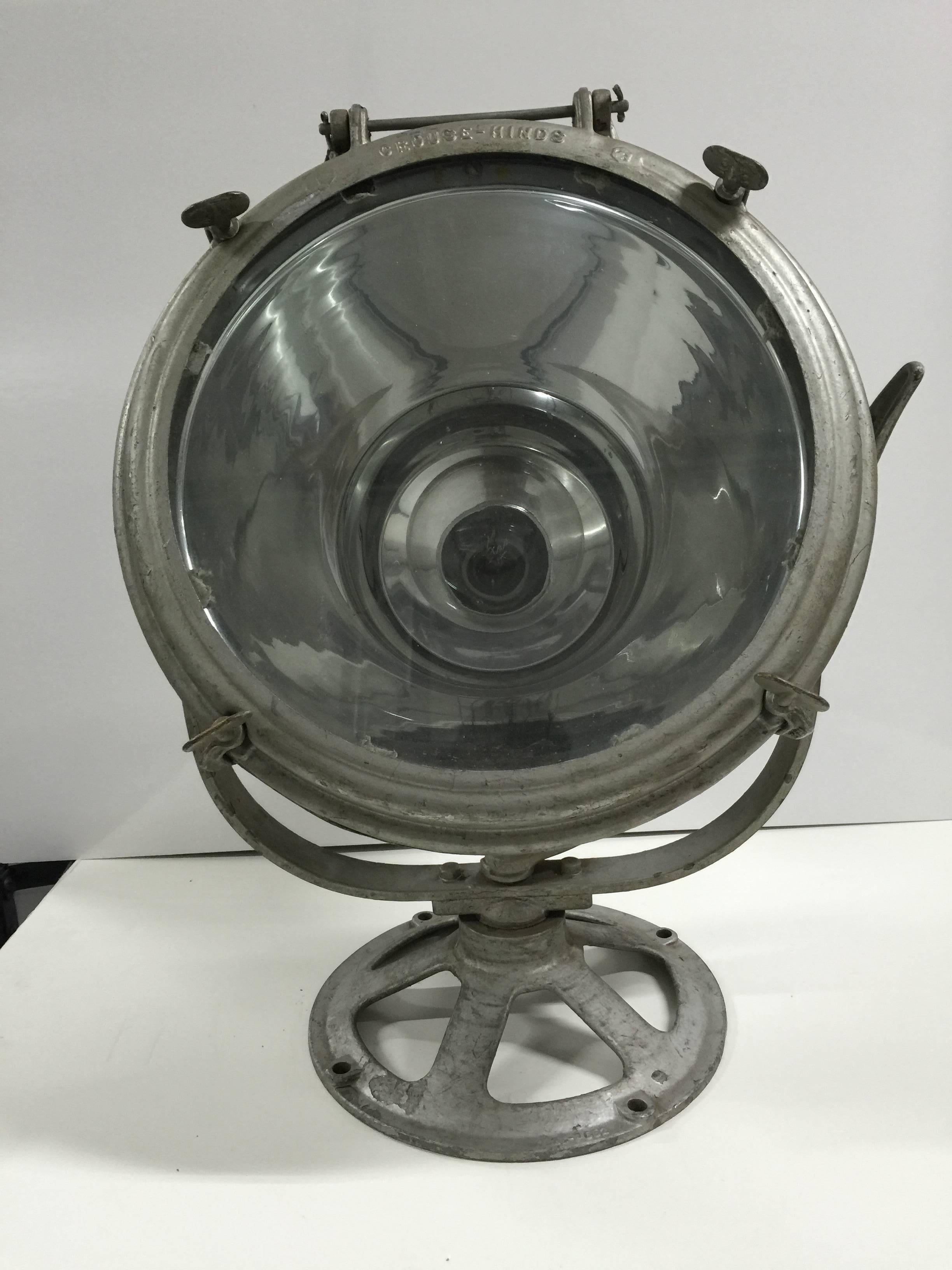 Early 20th Century spot light by Crouse Hinds.  USA.  Features a Pyrex round shade and fully adjustable head mounted on a wide round base.  For display purposes only; not tested for electrical use.  Base diameter, 16 inches.