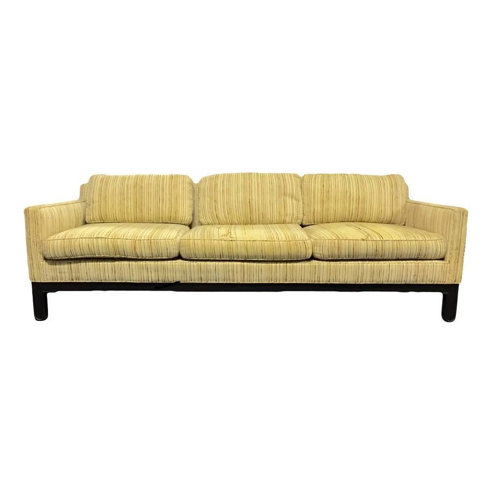 A solid and deep sofa resting on an espresso-stained, four-leg mahogany base with three-seat cushions and three back cushions. Made by Edward Wormley for Dunbar. Signed on seat decking fabric and on paper label, USA, circa 1950. Features