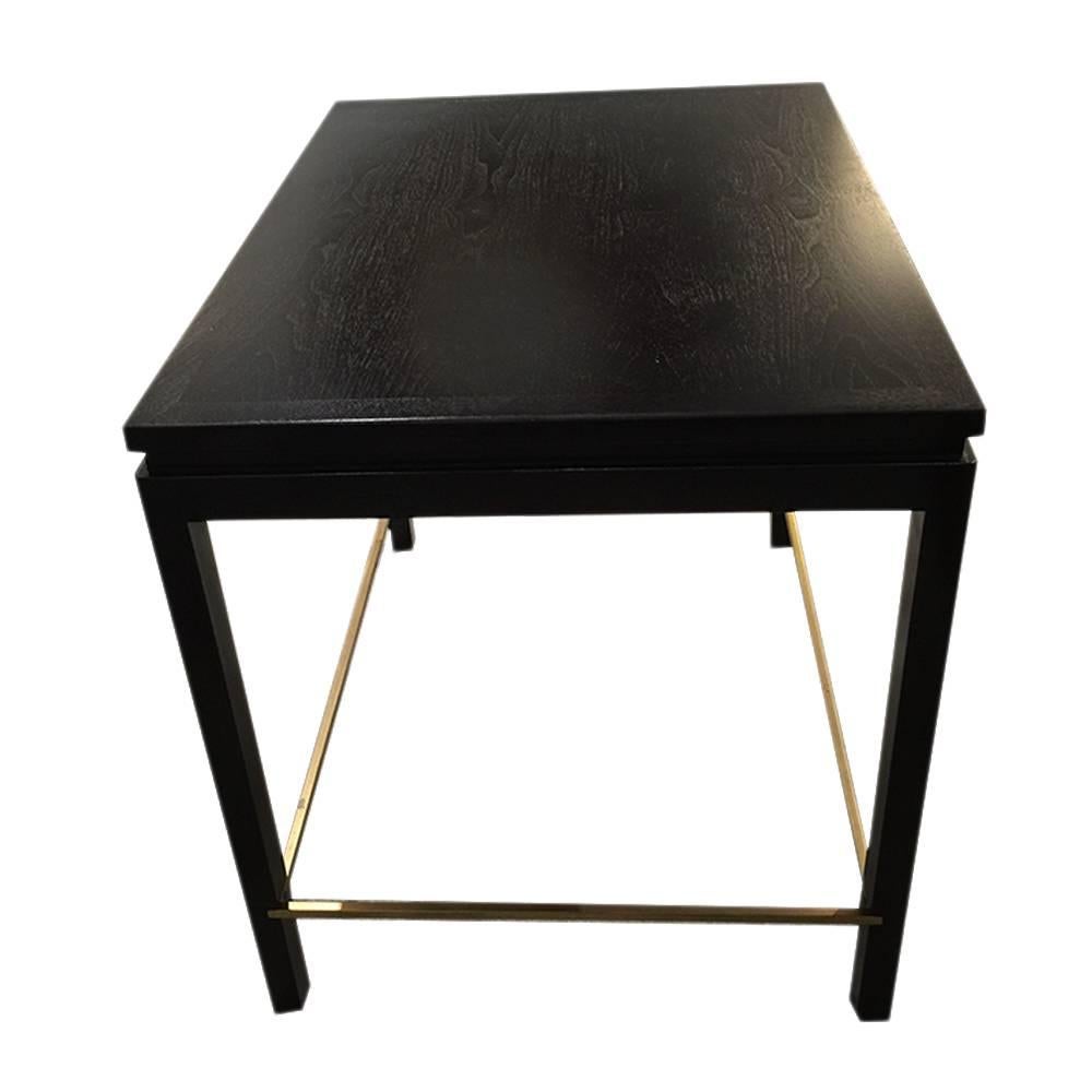 Ebonized mahogany end table with walnut inset top and brass stretchers. Made by Edward Wormley for Dunbar, USA, circa 1960. Signed with brass tag.  

From Dunbar's classical Chinese influenced Janus collection.

Dimensions:
22