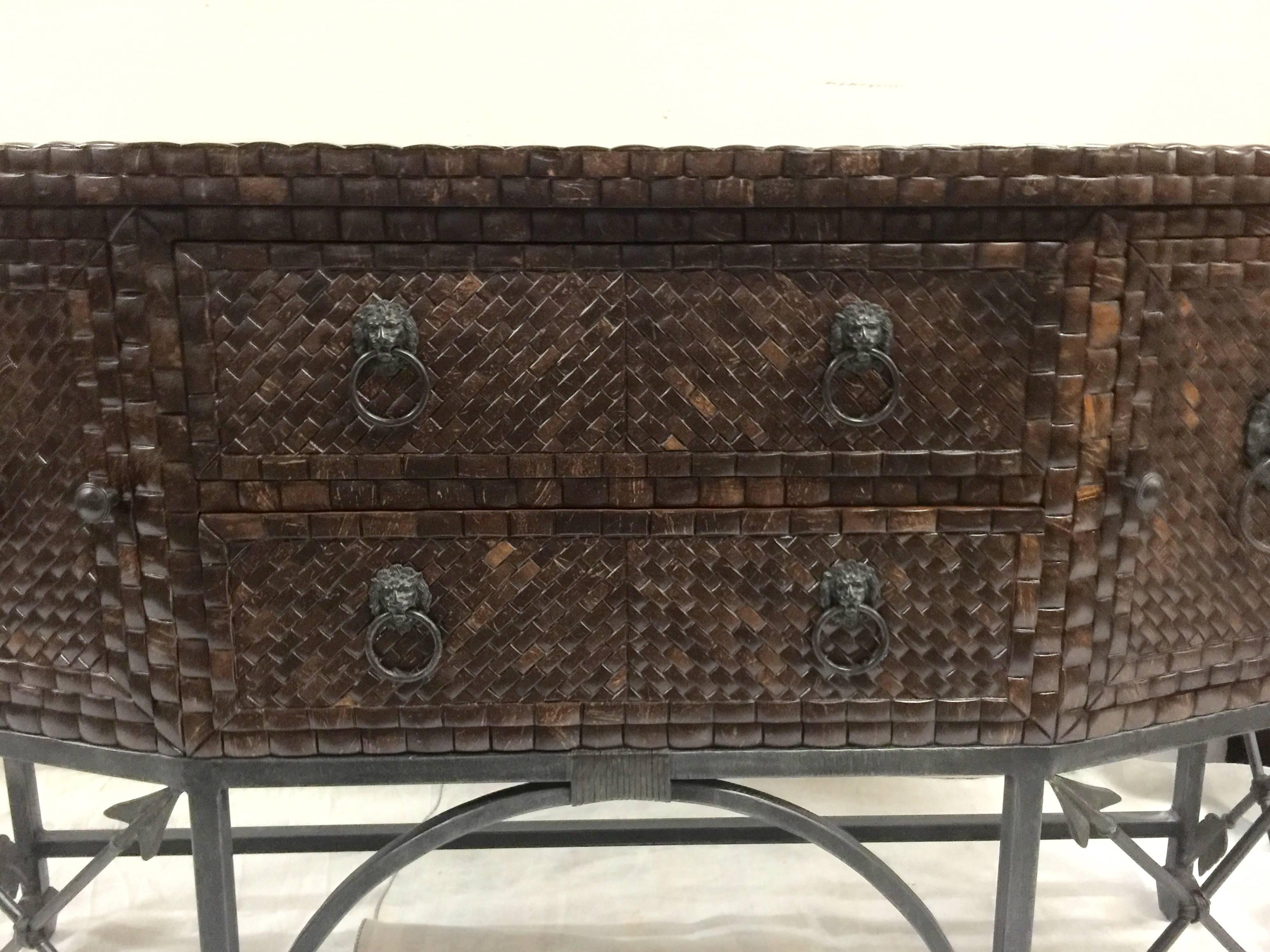 An exceptional sideboard inlaid with coconut shell and with a top of hammered copper square panels and resting on am arrow-motif iron base. Made by Maitland-Smith. Signed. USA, circa 1970. Features two center drawers and two side doors. Ideal as a