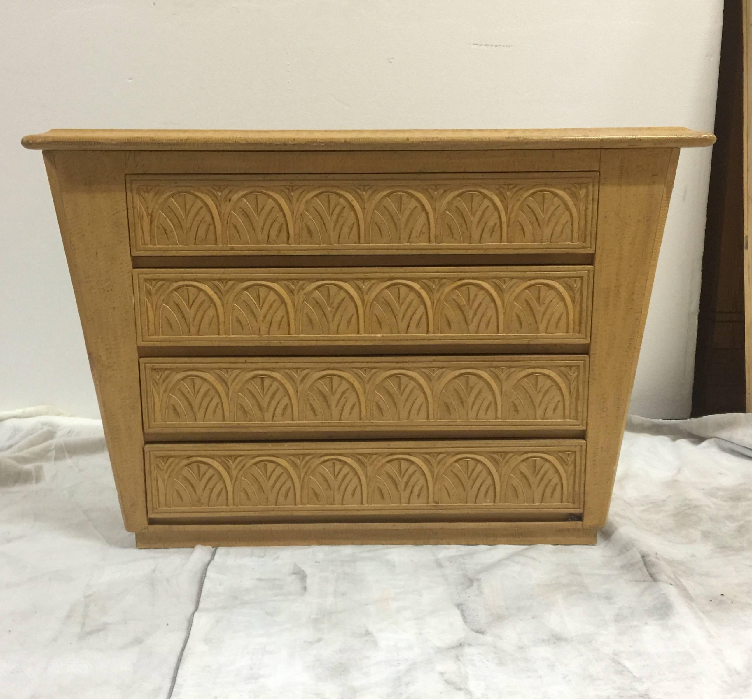 A blond wood dresser or chest with four drawers featuring a repeating carved design. USA, circa 1980. Finely constructed and versatile style.
