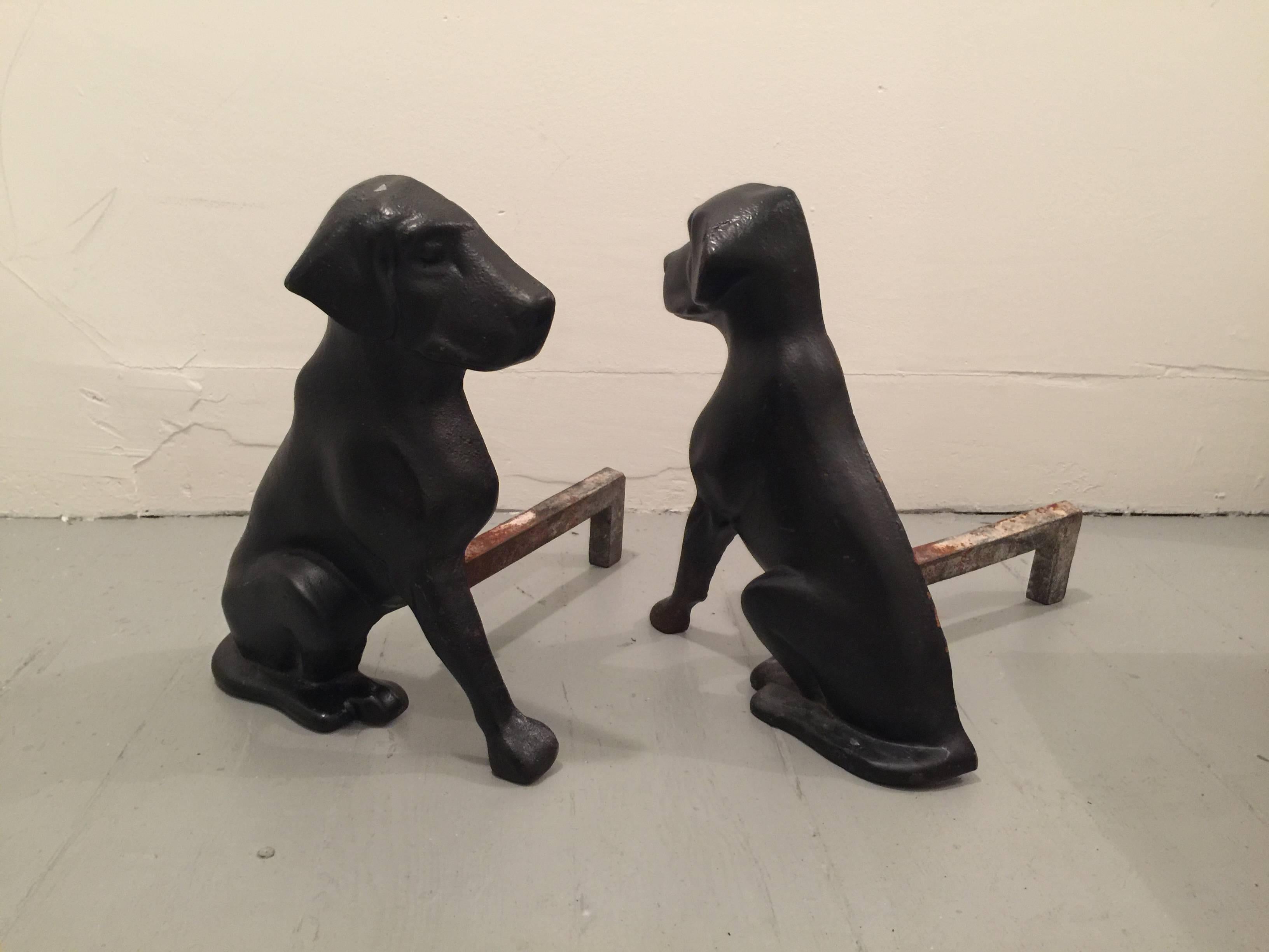 Pair of black cast iron andirons in the shape of Labrador dogs. Stamped 
