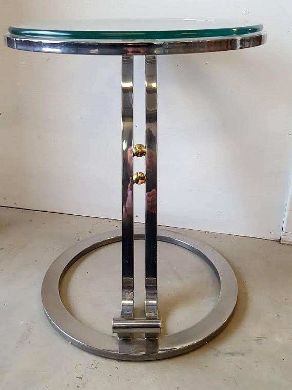 A very sleek and streamline pair of chrome and brass and glass occasional tables. Very sturdy and well weighted these cantilever form items are very chic with any interior.
Chrome is good and bright as is the brass accents found throughout.