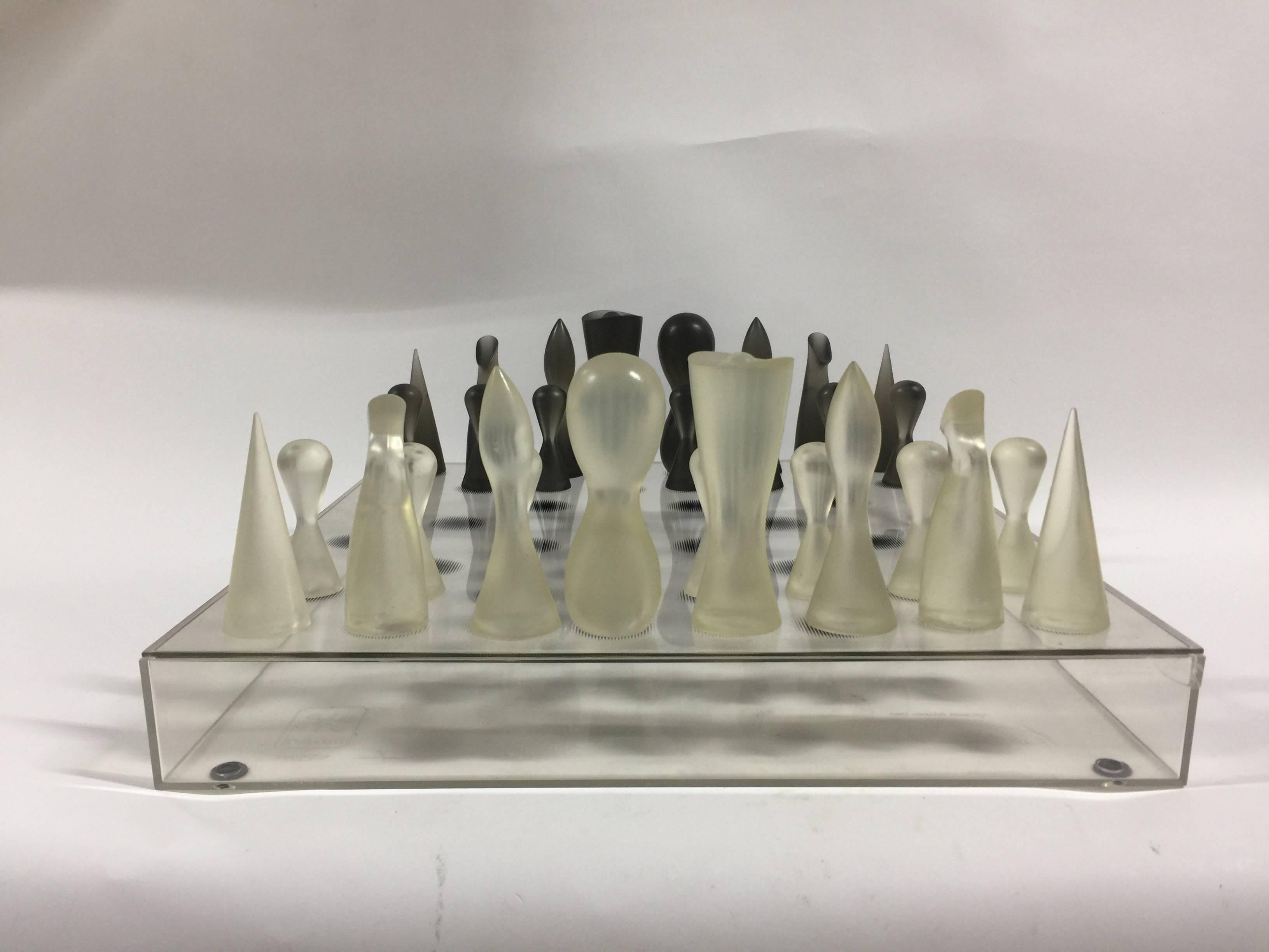 A Minimalist Lucite chess set designed by Karim Rashid (born 1960) for Bozart. Made in USA, circa 2001. Signed.

Made of thermoplastic rubber pieces in black and white with an acrylic see-through board, this chess set is in the collection of the