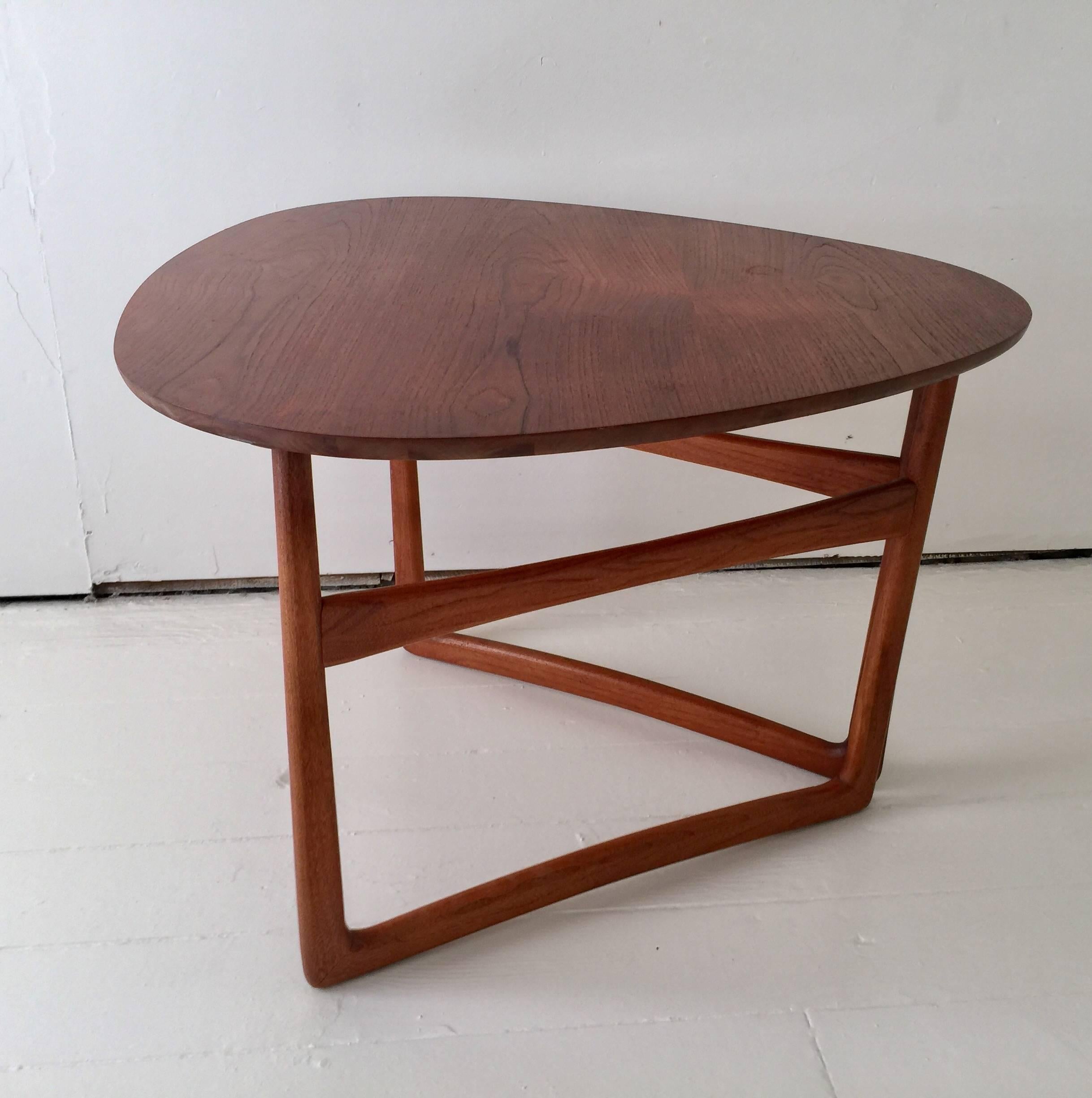 A collapsible side or occasional table in teak with folding gate legs and brass ball-joint detailing in the style of Peter Hvidt & Orla Mølgaard-Nielsen.

Marked and made by Lane. USA, circa 1950. 

One table available.