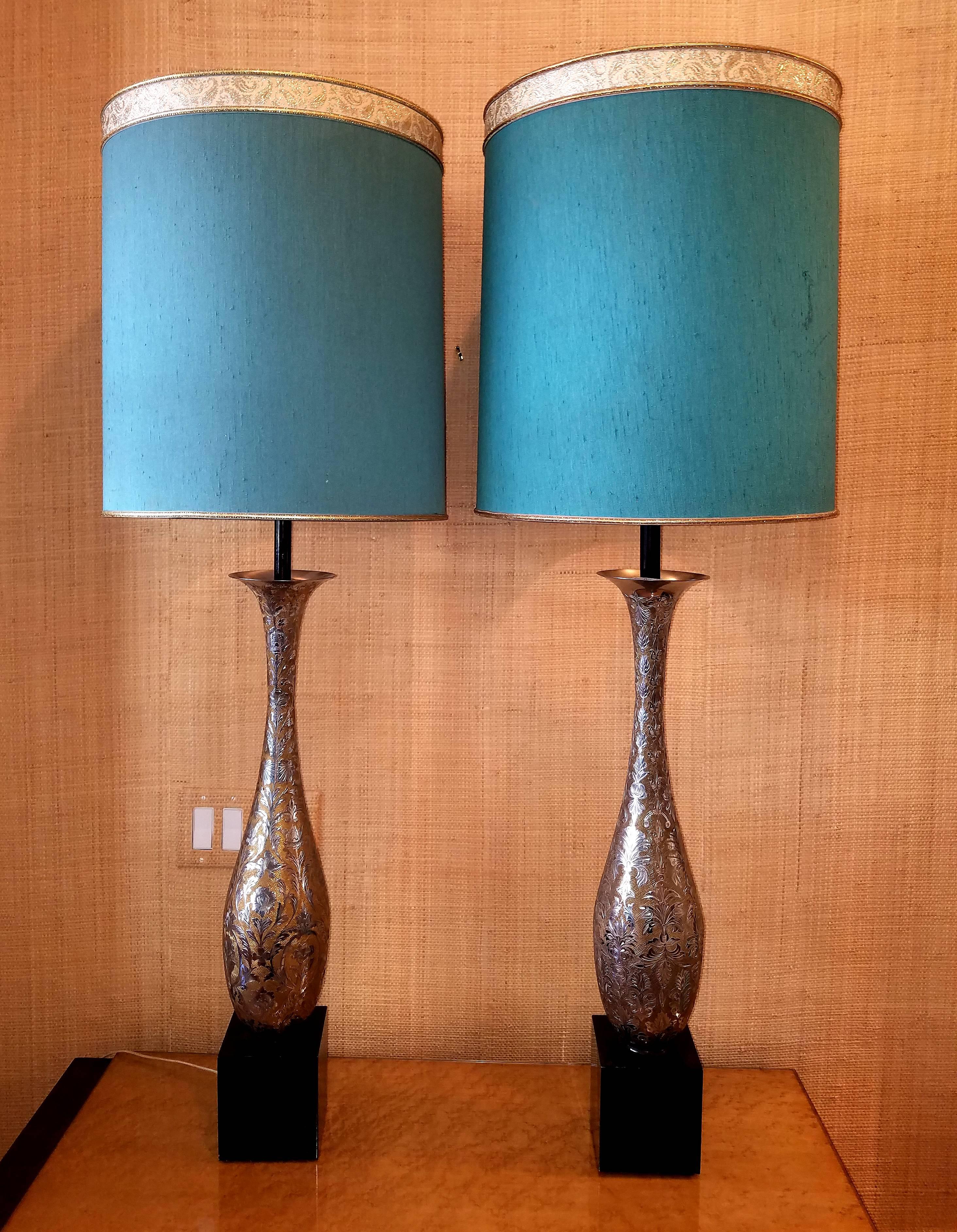 Pair of etched and silvered brass table lamps from India made in the Persian style. Large-scale and beautifully proportioned with delicate integrated decoration. Retaining the original shades. Each lamp has a different pattern. Beautiful and very