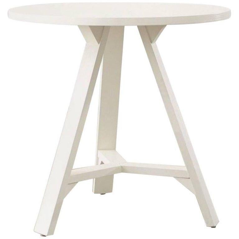 A round table styled after an antique English cricket table that may be used as an occasional table or small cafe dining table, USA, early 21st century.

Features original painted off-white finish with tripod base and stretchers.

Dimensions: 30