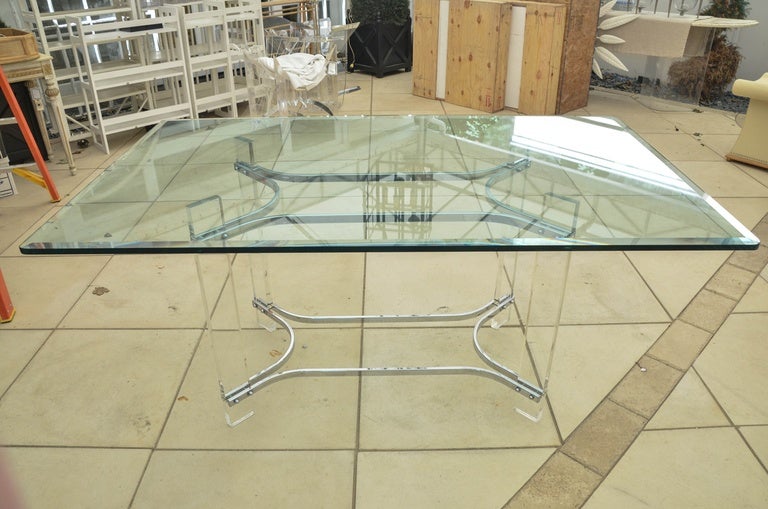 Mid-Century dining table by Charles Hollis Jones. The base is Lucite with chrome-plated metal supports. The glass top is 1/2 in thick with a 1 in bevel.