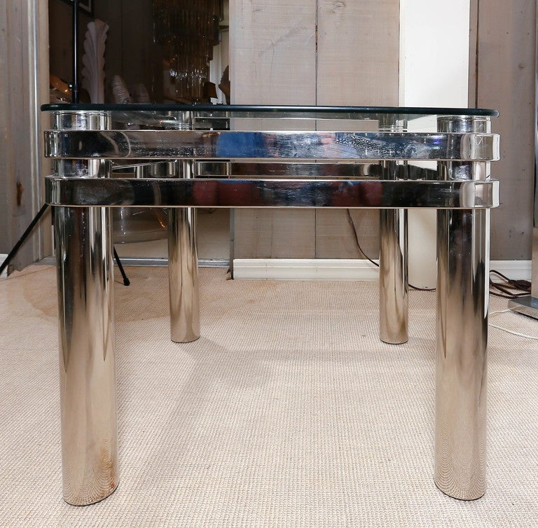 Attractive pair of chrome glass top occasional tables with turned chrome wraparound accents and chrome tubular legs.