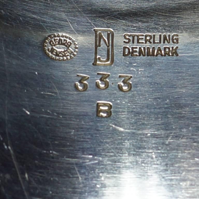 Sterling silver brooch with multiple hues of blue enamel. Designed by Nanna Ditzel for Georg Jensen. Model 333 B. 1970's Marked with Georg Jensen hallmark, Nanna & Jorgen Ditzel hallmark, STERLING DENMARK, 333 B.