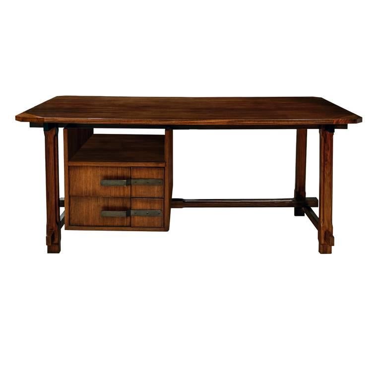 Unique desk by Ico Parisi.
Produced at Capiago Intimiano by Fratelli Rizzi, 1959.

Walnut desk having a rectangular top with chamfered corners. Its case holds two drawers with forged burnished brass pulls. The legs and cross stretchers are mortised