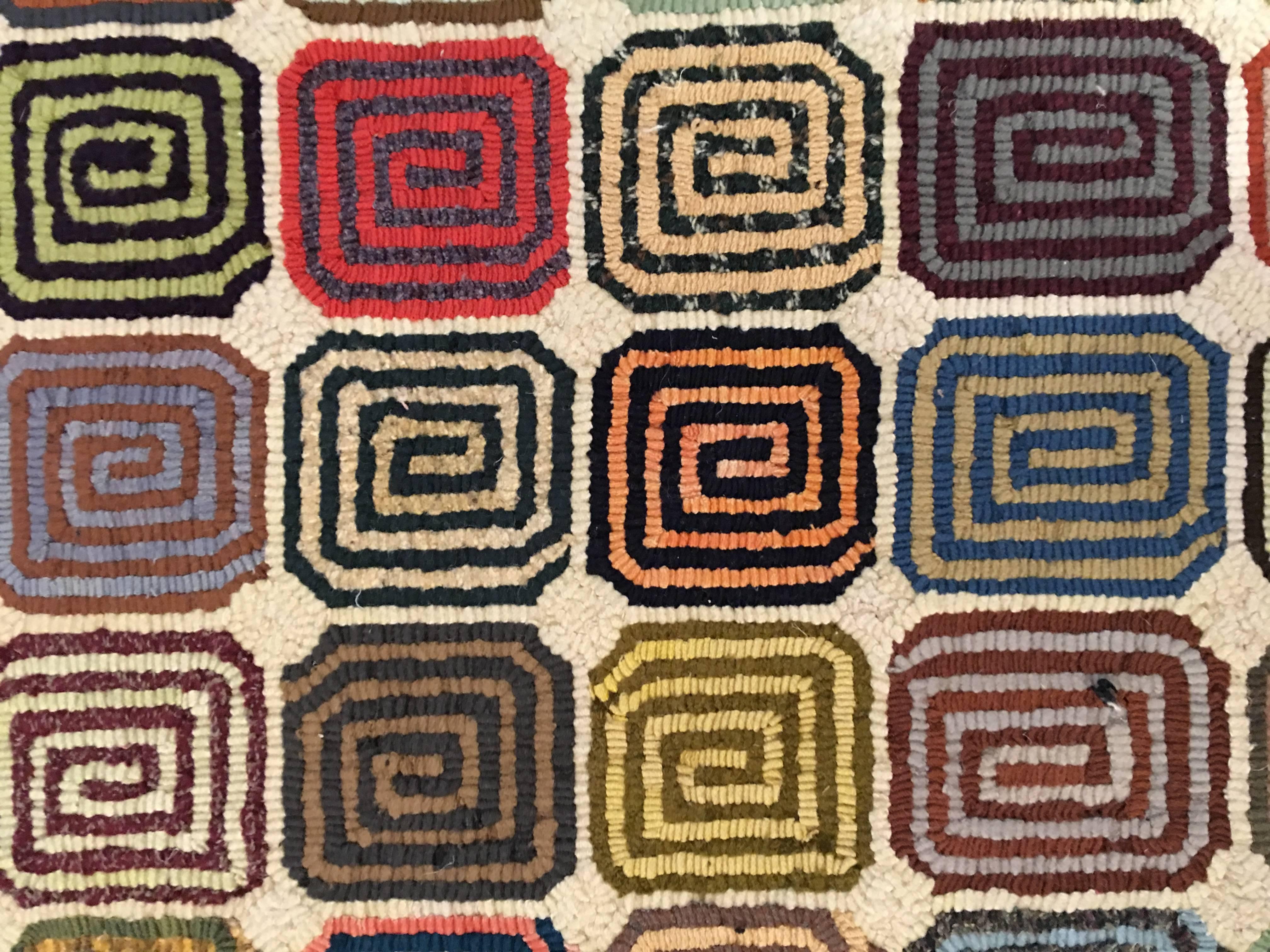 Handmade modern design rug with spiral design.