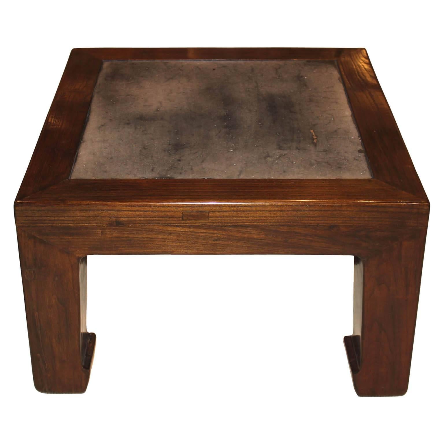 Chinese elm wood coffee table with vintage stone insert can be used in a contemporary home.