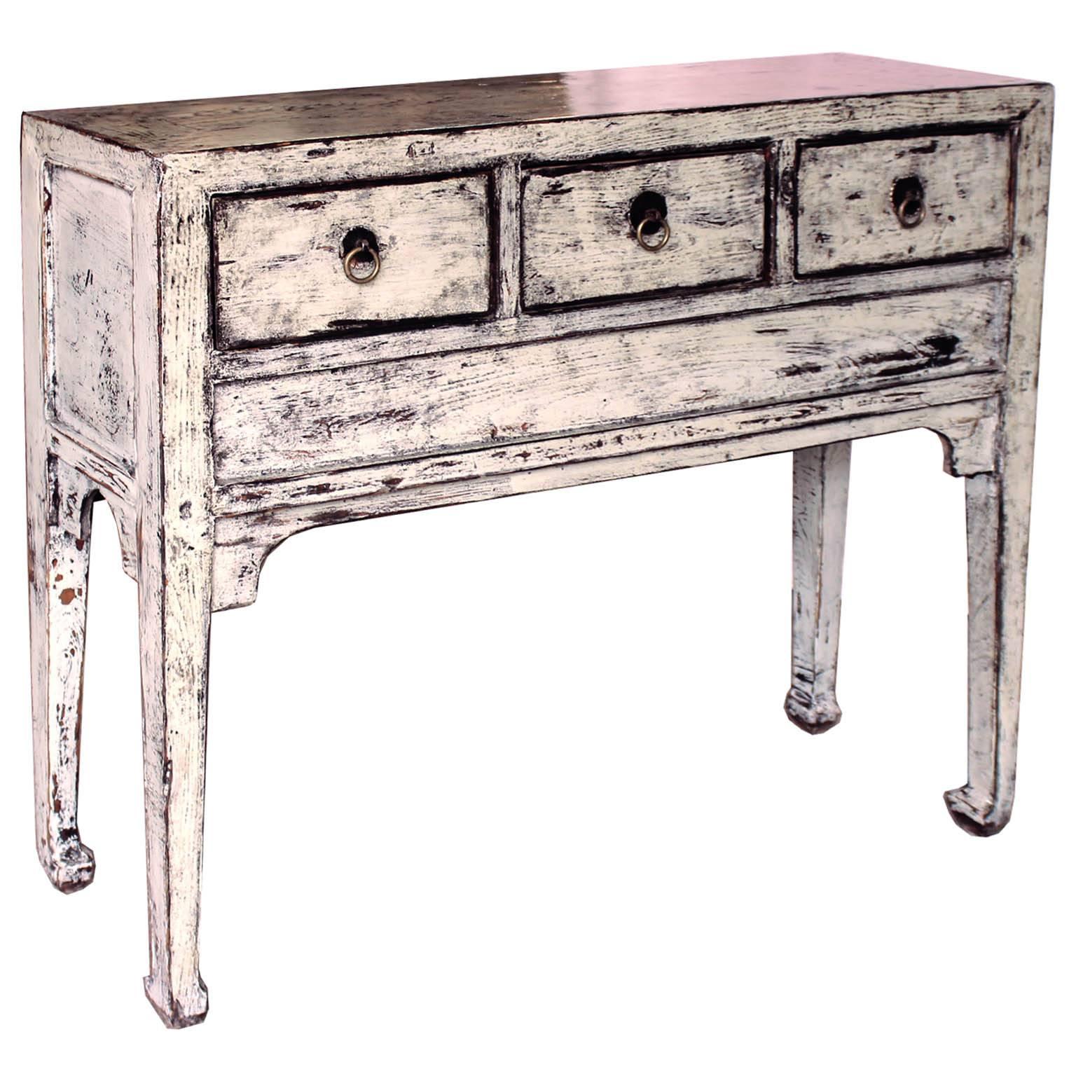 Three-drawer gray console table with elegant horse hoof-style feet and curved bottom skirt. Place in a hallway or entryway with a lamp and accessories on top. New hardware, circa 1900s.