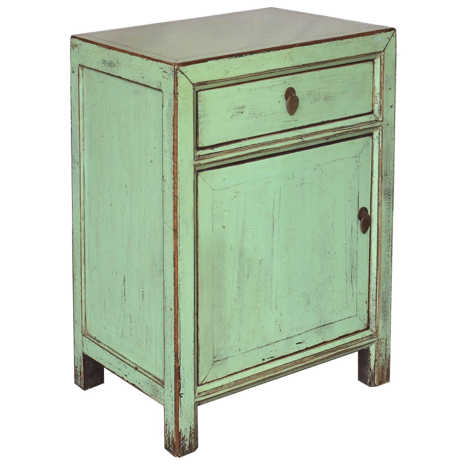 Contemporary one-drawer side chest with exposed wood edges and celadon lacquer finish will add a pop of color to a modern bedroom.  Chest shown on the left is no longer available.