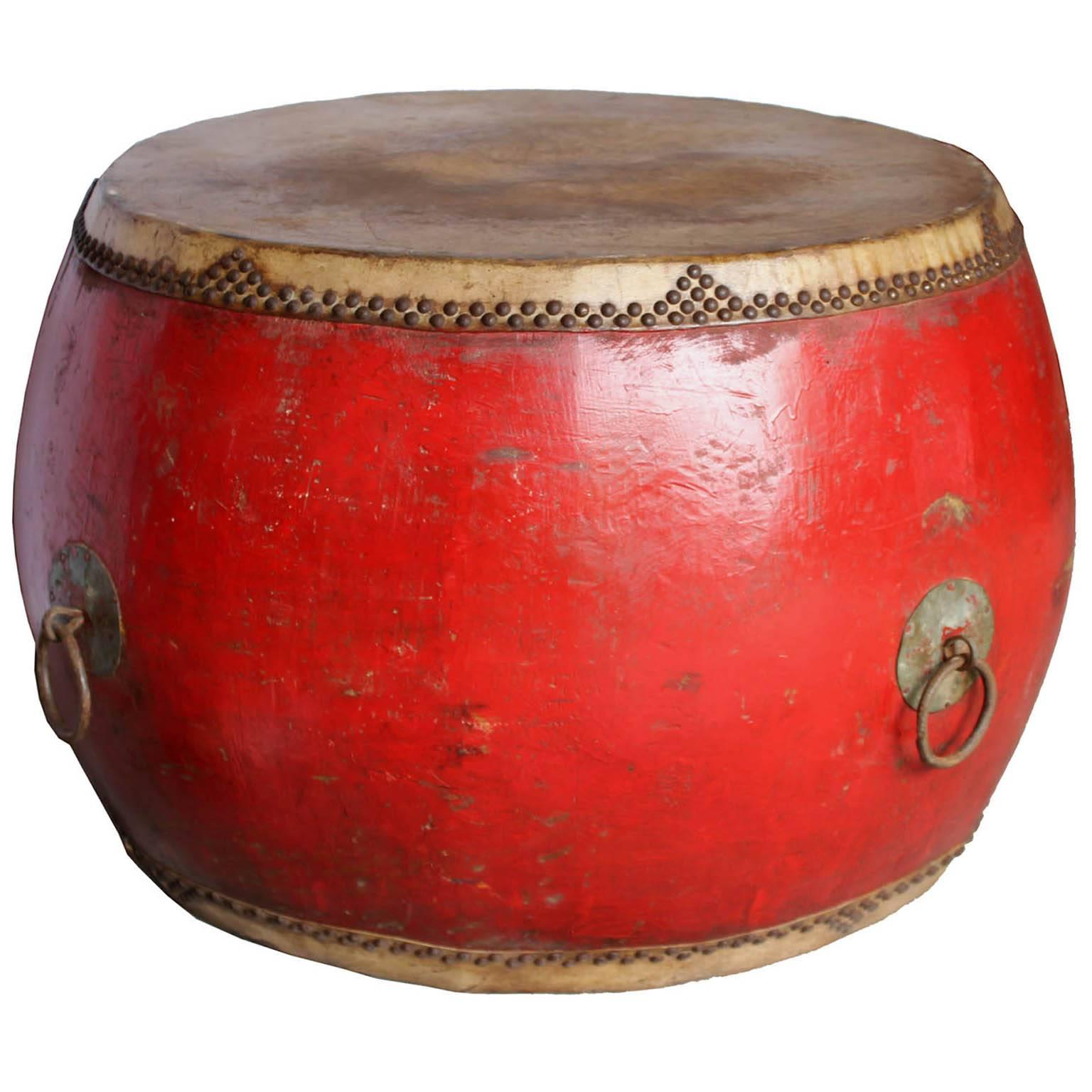Original vintage drum was used in ceremonies to celebrate various community events. Red lacquer drum with elmwood base and leather covers makes an interesting table.