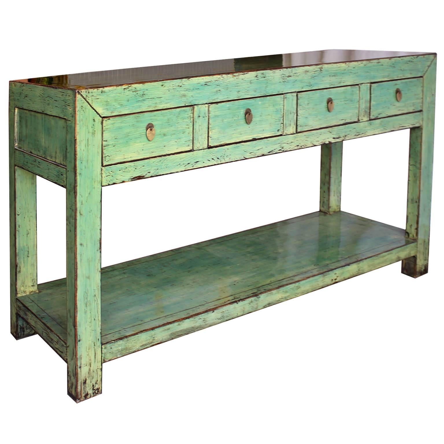 Hand-lacquered four-drawer console table with clean lines and exposed wood edges. Add a pop of color by placing the console behind a sofa, in an entryway or against a living room wall beneath some art or a flat screen tv.