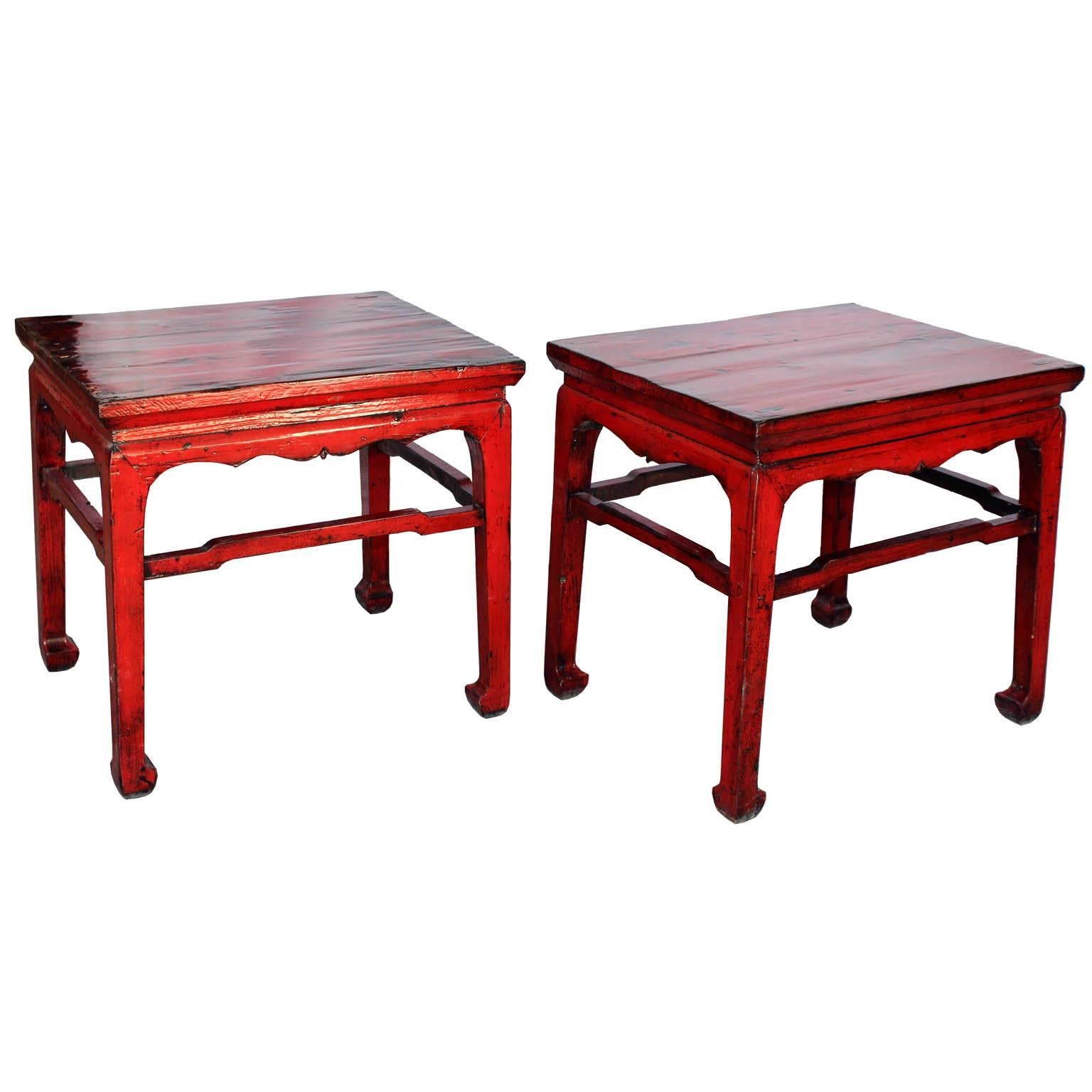 Pair of red lacquer tables with scalloped lip, support bars and horse hoof-style feet. Use in front of a sofa as coffee tables or as a side table next to an armchair. China, circa 1900.