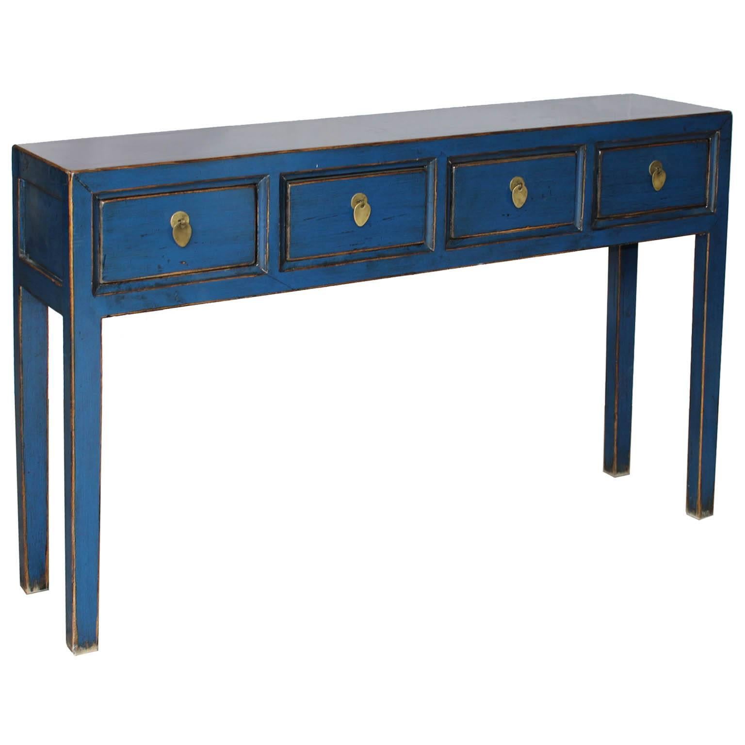 Place this contemporary blue lacquer console table with clean lines and exposed wood edges behind a sofa or in an entryway with accessories on top. This blue console table will bring a pop of color into a modern interior.