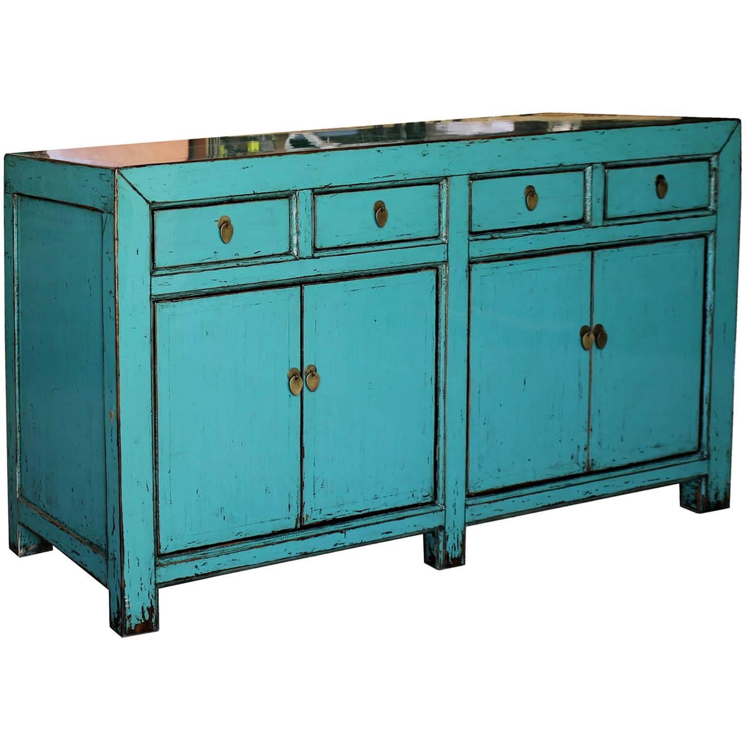 Light blue or turquoise lacquer sideboard with four drawers and elegant straight lines brings in a pop of color to any contemporary interior.