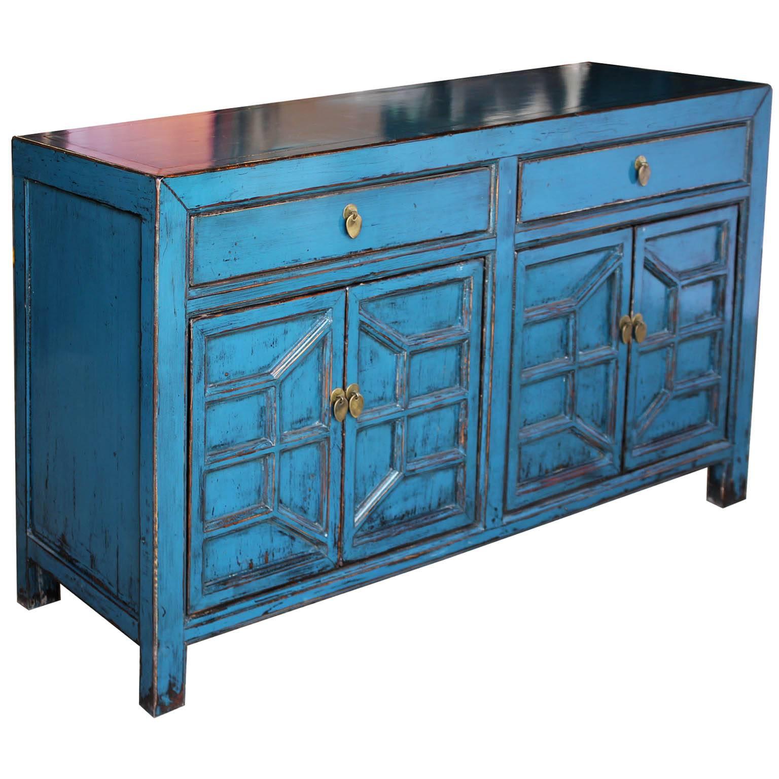Contemporary blue lacquer sideboard with geometric patterned doors brings a pop of color to the living or dining room.