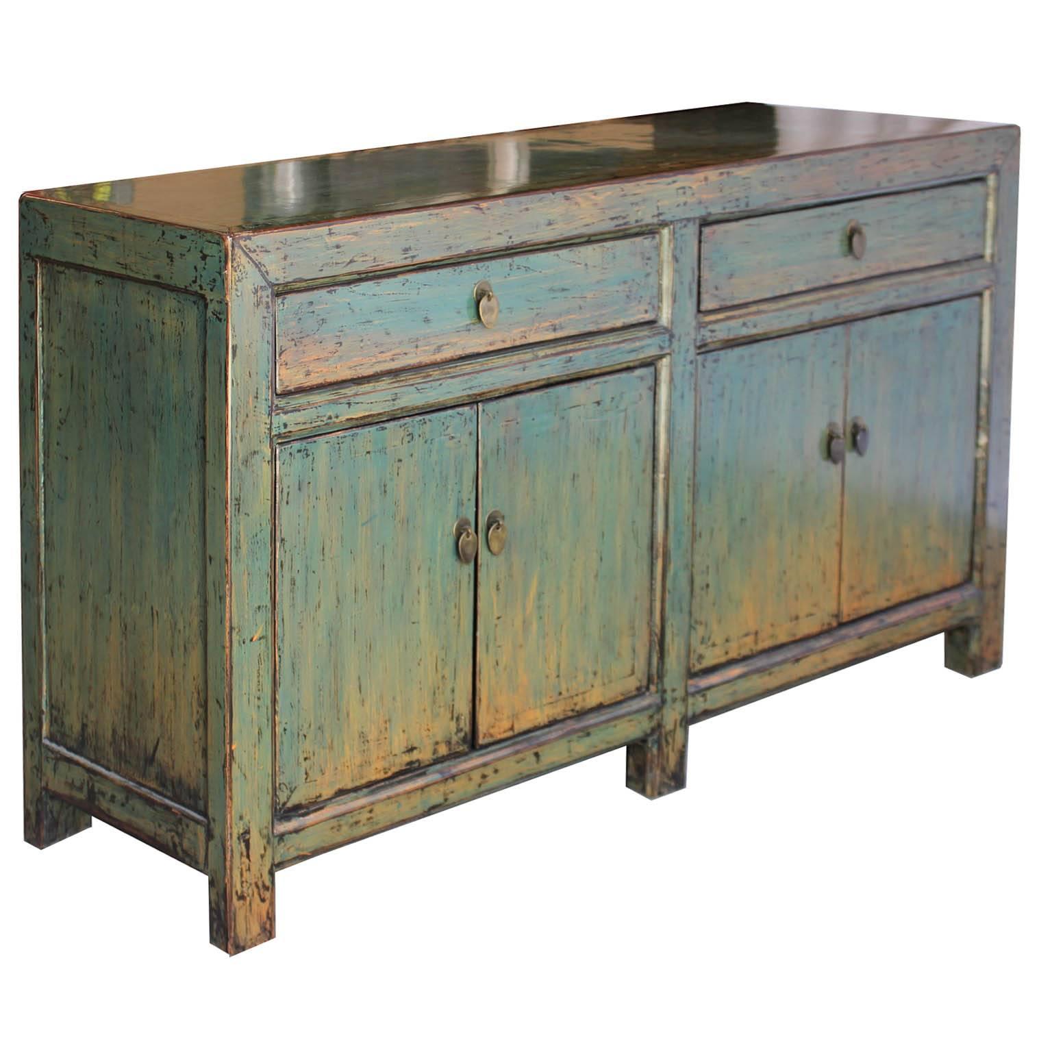 Two-drawer sideboard with hand-painted green/blue lacquer can be used as a server in the dining room or beneath a flat screen TV or artwork.