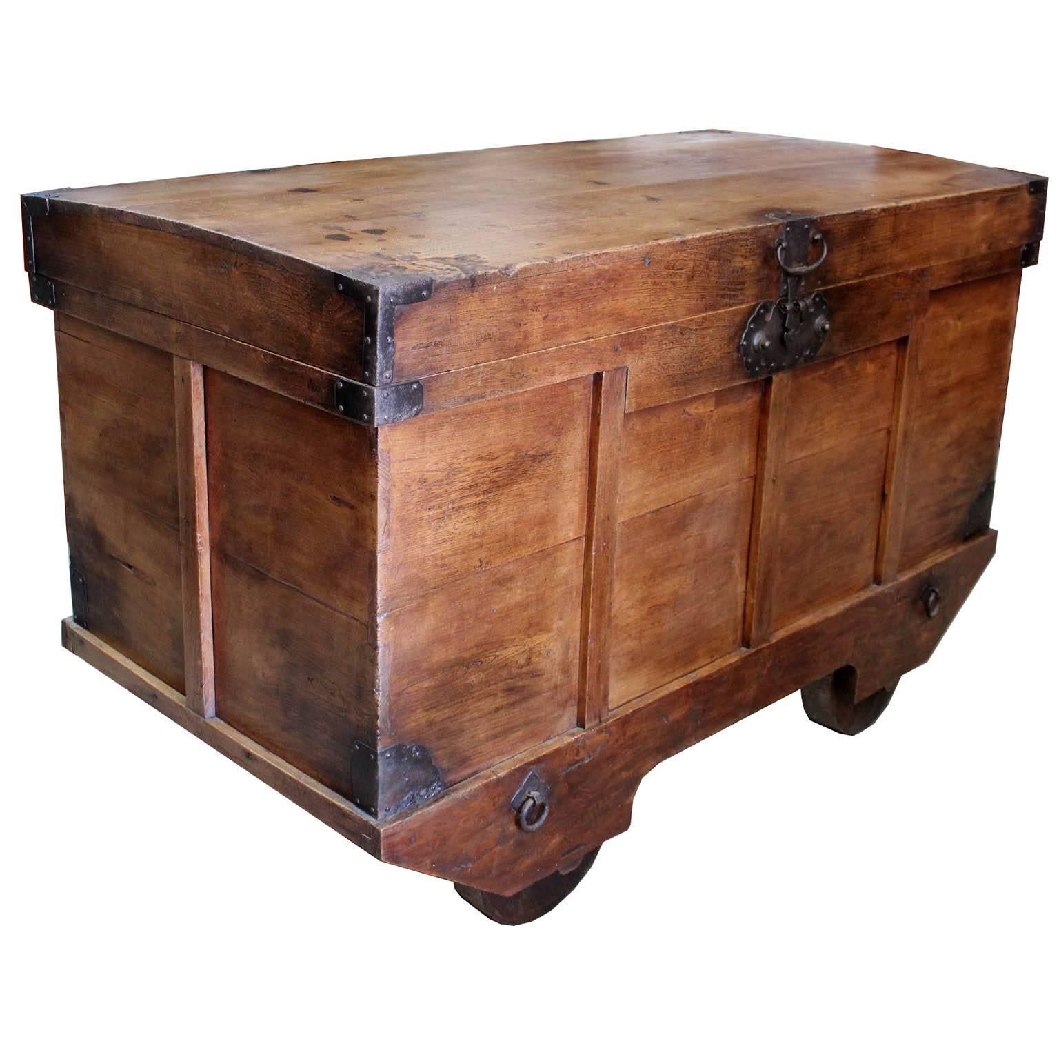 Original Japanese Nagamochi dansu from northern Japan used to store extra blankets and clothing inside the wheeled trunk. Wooden wheels were used to transport the tansu from the house in case of a fire. Sugi (cedar) wood and hand-forged iron