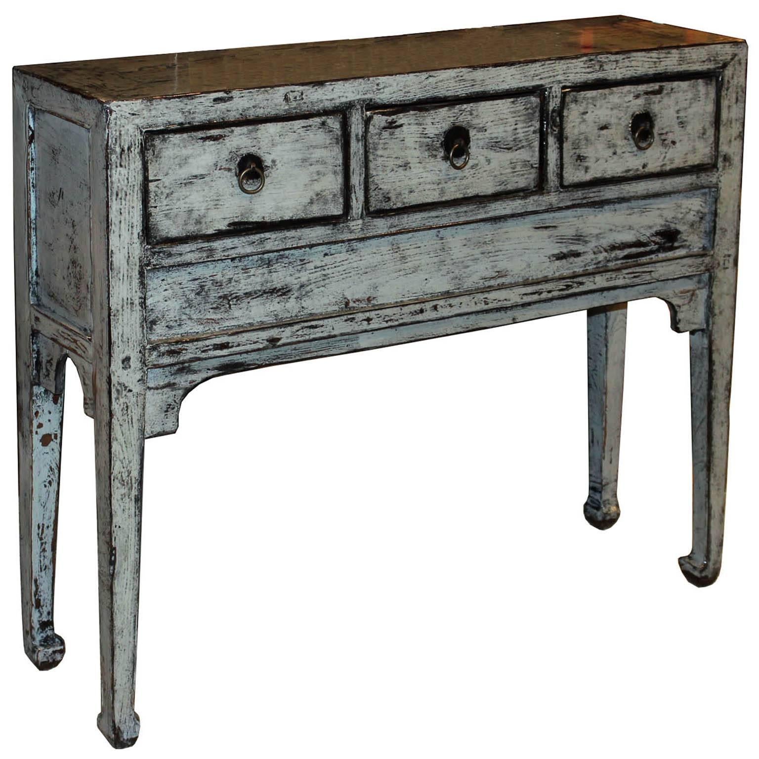 Three-drawer grey console table with elegant horse hoof-style feet and curved bottom skirt. Place in a hallway or entryway with a lamp and accessories on top. New hardware, circa 1900s.