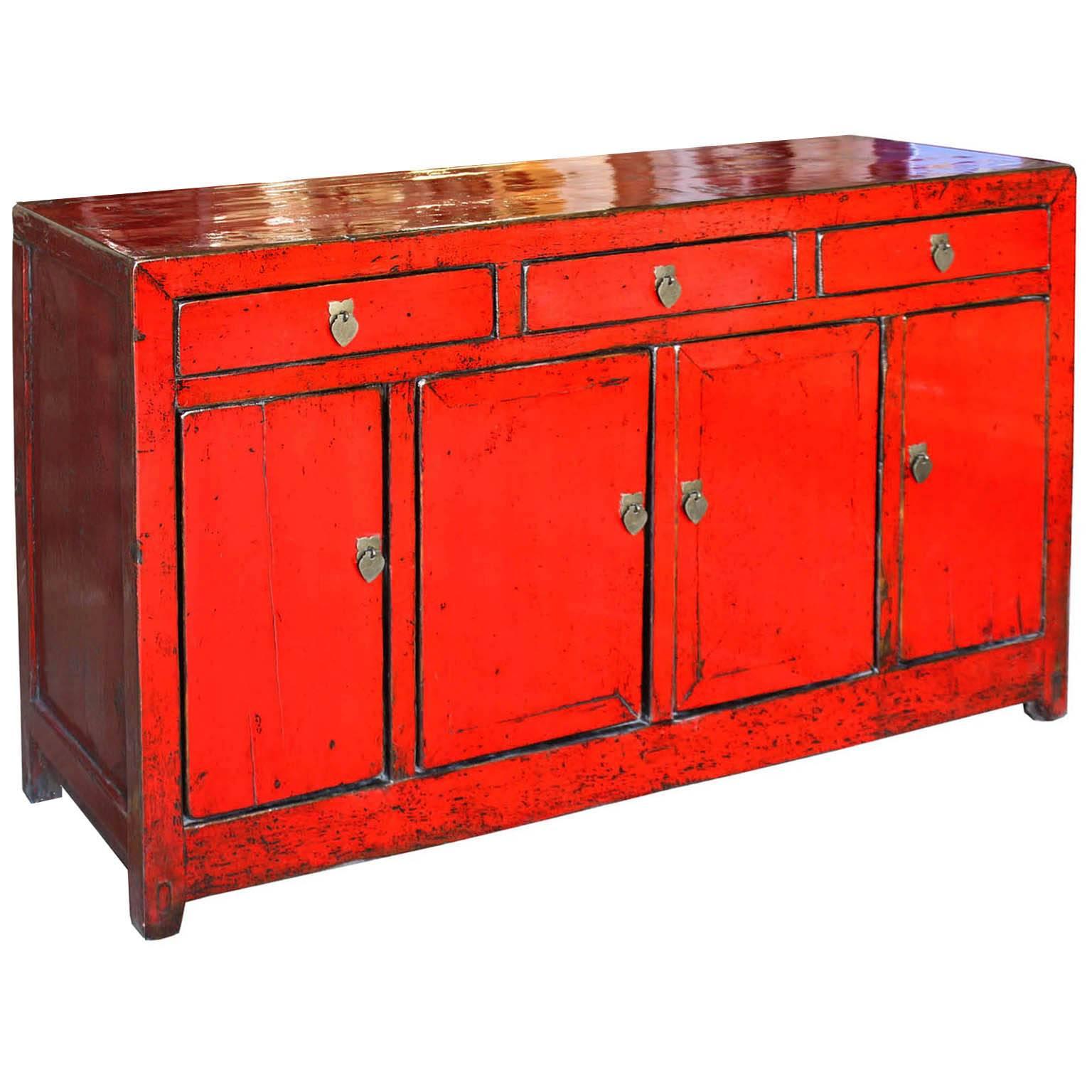 Red lacquer sideboard brings a pop of color to a contemporary living or dining room. Middle bar removes for easy interior access. New interior shelf and hardware. Dongbei, China, circa 1900s.