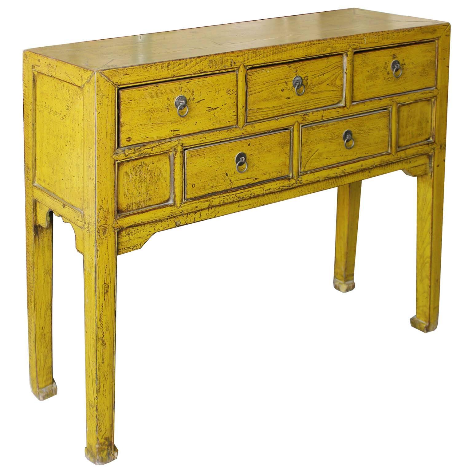 Mustard green/yellow lacquer console table with multiple drawers with elegant horse hoof-style feet can brighten up an entry way. New hardware. Shandong, China, circa 1920s.