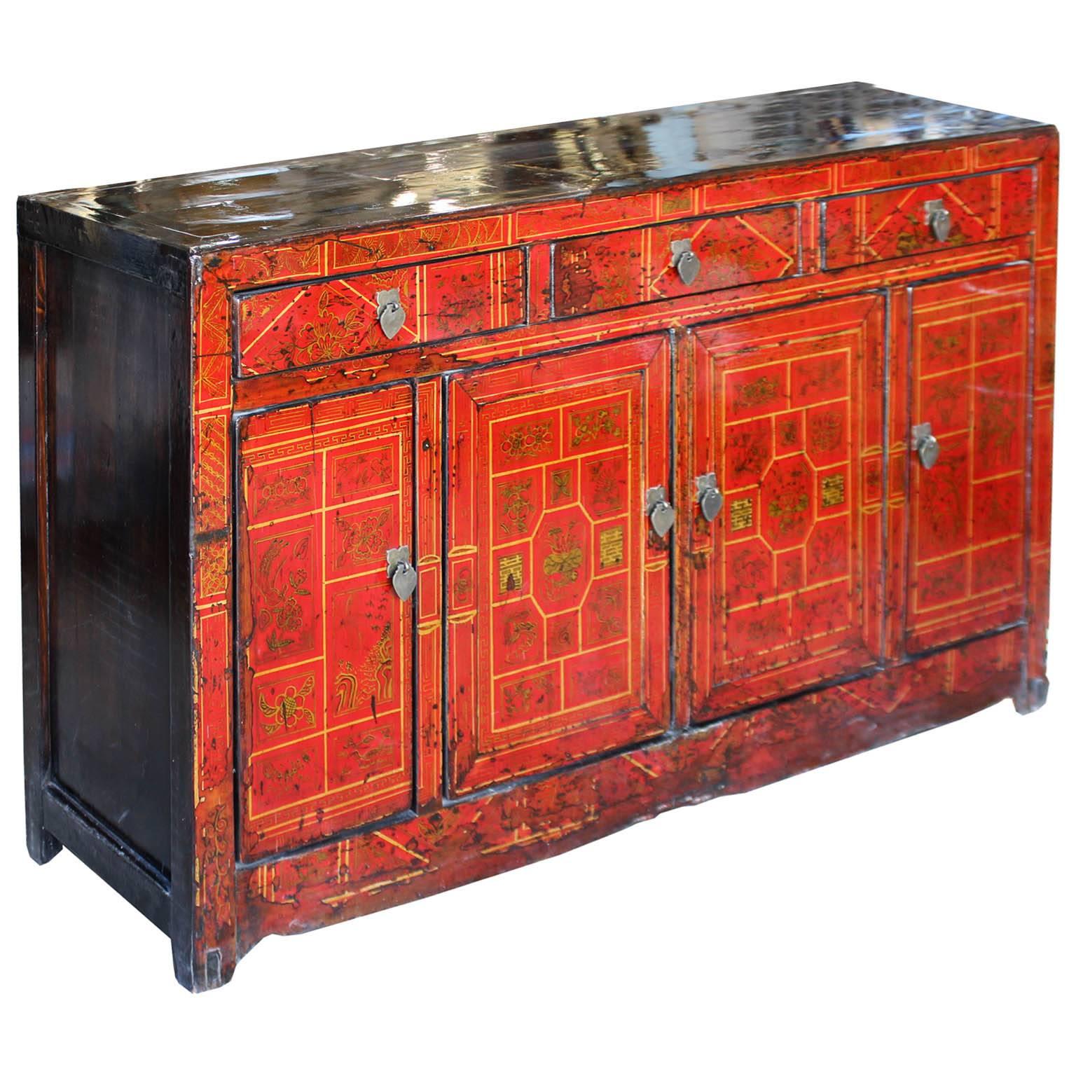 Red sideboard with hand-painted gold symbols for happiness and prosperity would be a statement piece in a living or dining room. Brown elmwood tone top and sides. Middle bar removes for easy interior access, with new interior shelf and hardware.