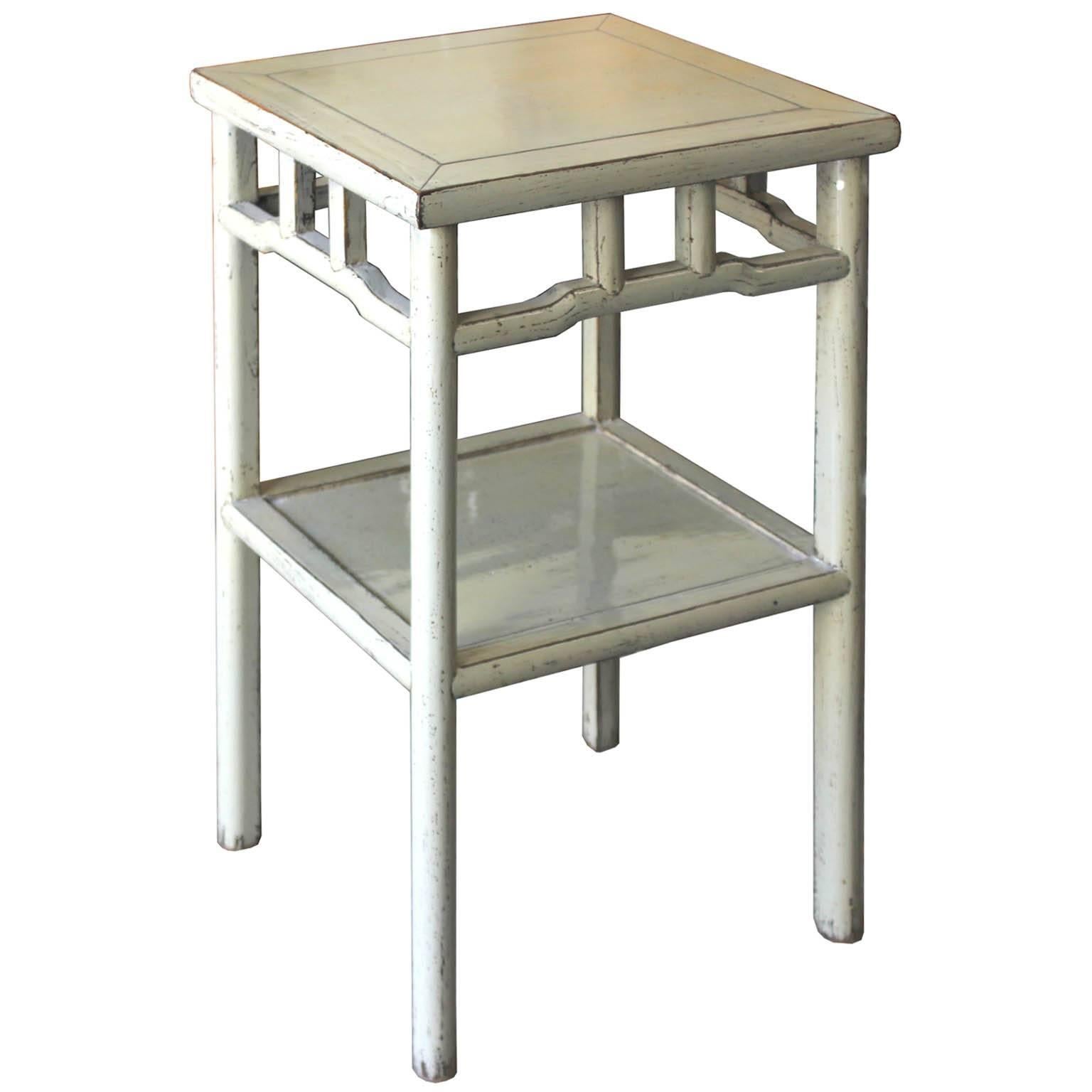 Contemporary light gray lacquer end tables with exposed wood edges and bottom shelf can be used as bedside tables. Available and priced individually.