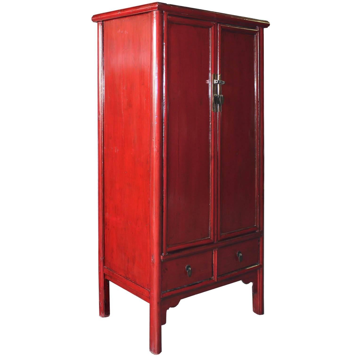 Chinese red lacquer wardrobe chest with clean rounded lines and exposed wood edges can be used to store clothing or to house a flat screen TV. Four drawers, two behind the doors. Middle vertical bar removes for easy interior access. Place this red