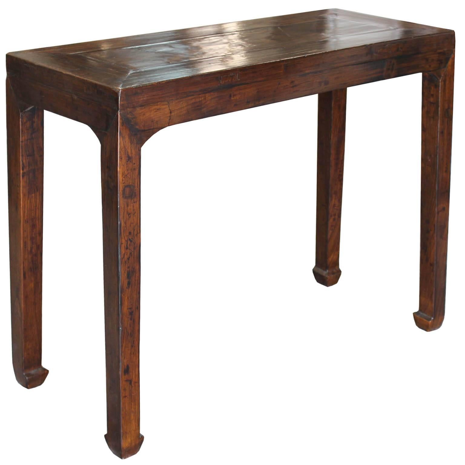 Elm console table with horse hoof-style feet can be used in an entryway with a lamp on top or as a bar table in the living room.