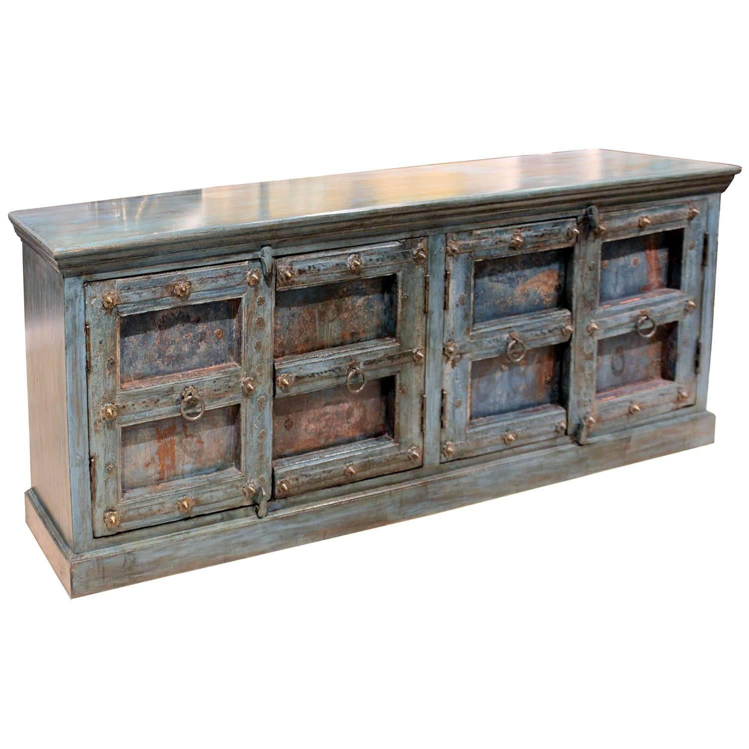 Indian buffet made with reclaimed wood on top and sides and finished in blue. Four doors with original hardware from an antique haveli from the Gujarat province. Place in the living room for a subtle source of color or in the dining room as a server.