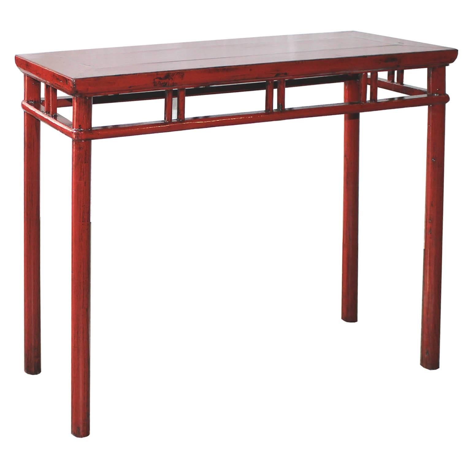 Red console table with support bars and rounded legs. Use in a contemporary interior behind a sofa or in an entry way for a pop of color, China, circa 1890s.