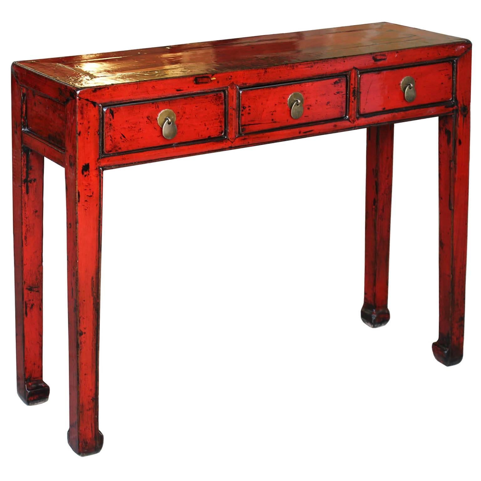 Bring a pop of color into your entry way with this red lacquer console table. Exposed wood edges, elegant horse-hoof feet and clean lines make a perfect fit for a contemporary interior. New hardware.