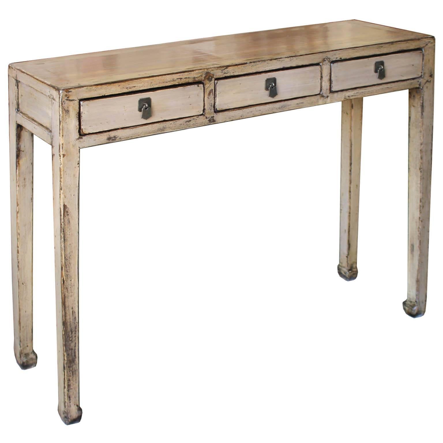 Contemporary parchment/gray lacquer console table with clean lines can be placed at the end of a hallway or in an entryway.