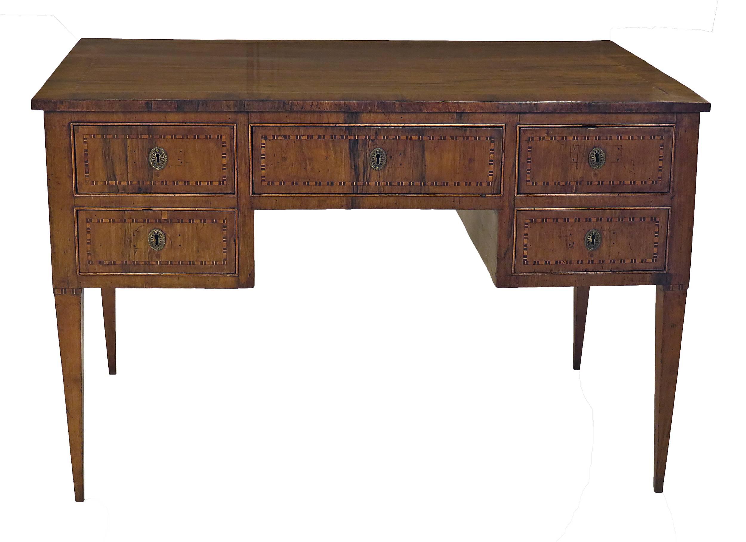 A handsome Italian walnut inlaid writing table or dressing table or desk made in the north about 1810 in the neoclassical manner. The desk has been tightened and polished with some small repairs to veneer. This piece is finished on all four sides so