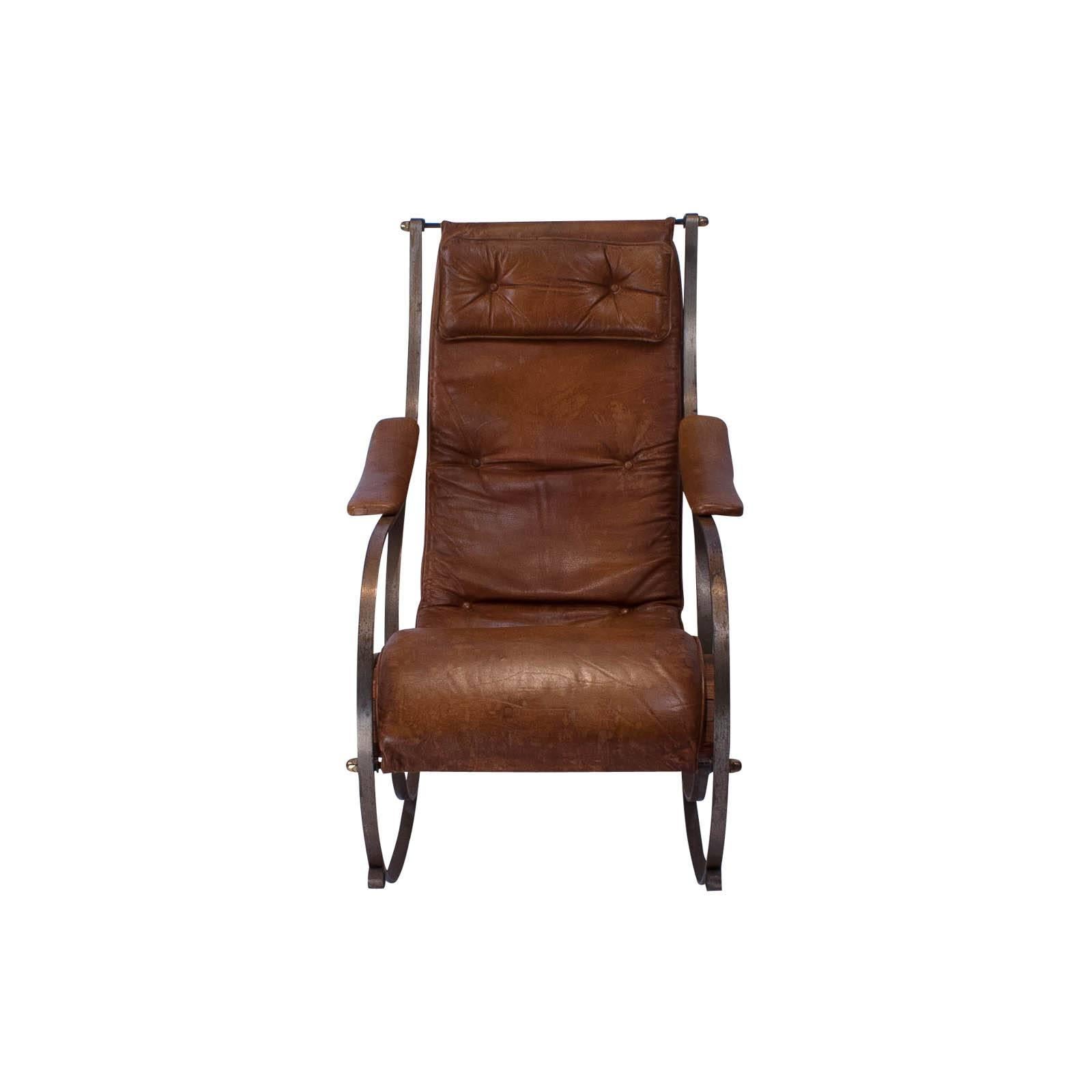 An original steel and leather rocking chair by R. W. Winfield, Birmingham England. This design first shown at the Great Exhibition of 1851. The leather, canvas, brass original. A couple of the wooden slats supporting the seat remade. Some attention