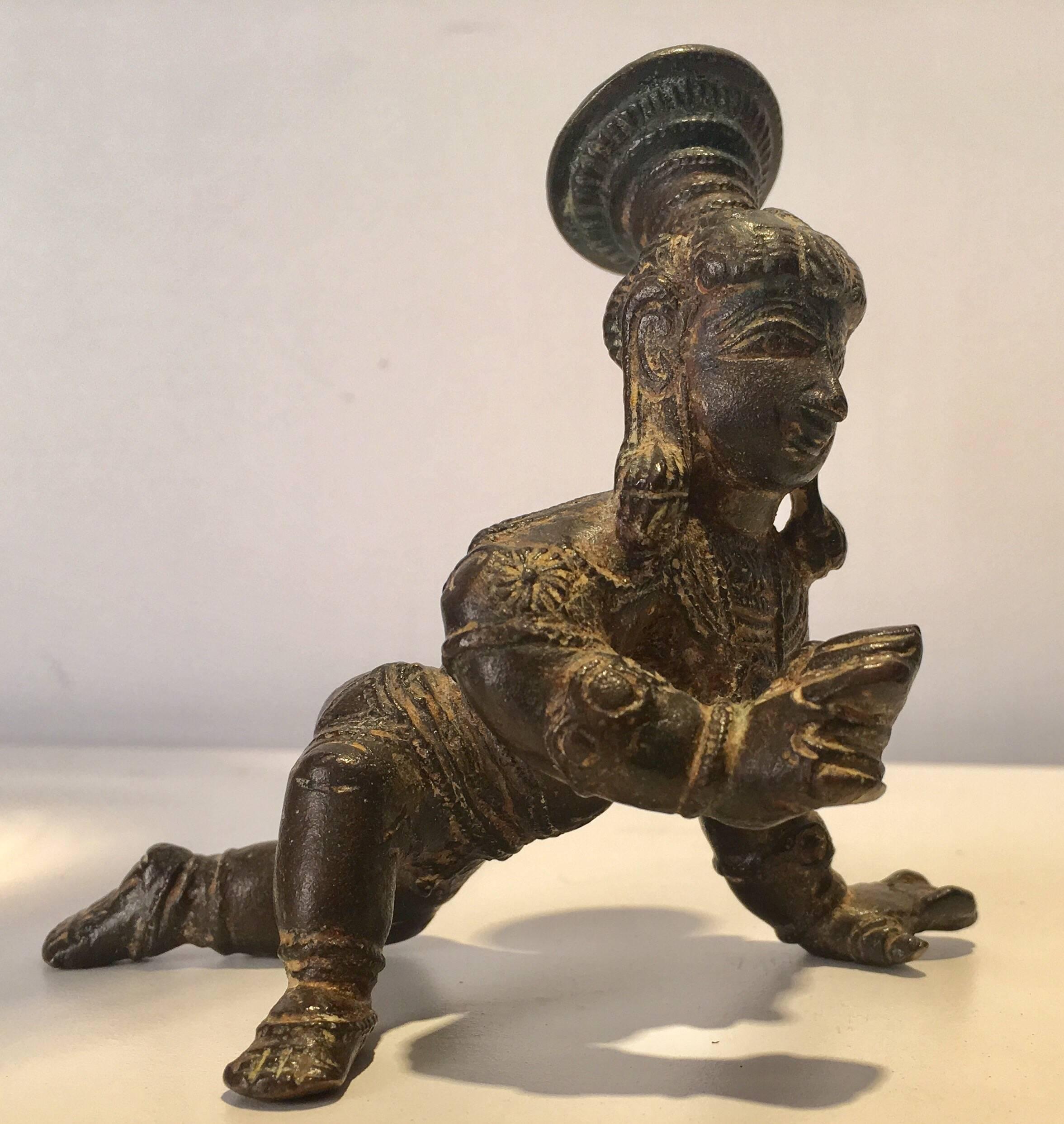 Charming bronze casting of the Hindu god Krishna as a baby. Deaccessioned from an old museum collection associated with a university. Good patina with well cast details. Lost wax casting. Closest example I could find was dated to the Vijayanagara