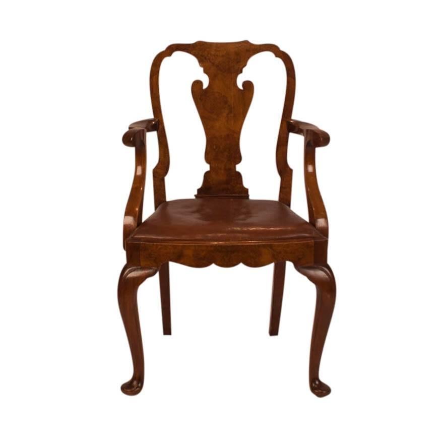 English walnut and burled walnut armchair made in England circa 1880 after designs first done circa 1720. The frame is solid and in good condition with an older leather seat.