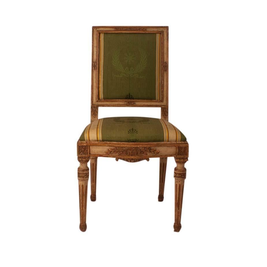A good set of four Louis XVI period cream and gilt painted side chairs on hardwood frames, circa 1780, France. Solid frames in good condition with older but very nice upholstery.
